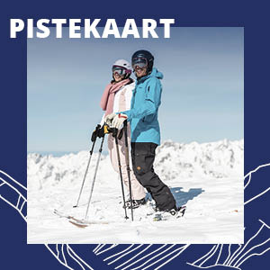 Koppel skiërs genietend van besneeuwde toppen en blauwe lucht – download de pistekaart voor Vaujany & espace Alpe d’Huez